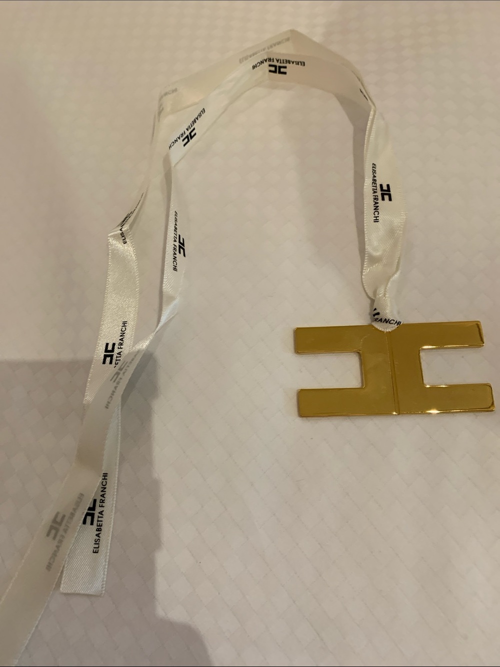 Authentic brand new Elisabetta Franchi golden pendant , accessory with ribbon.